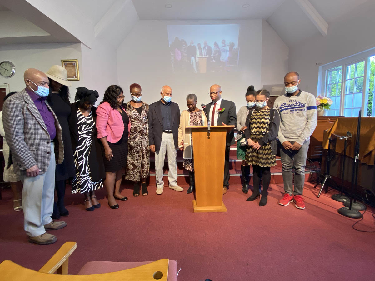 Gloria Edwards & Pastor Mario Phillip with friends and family